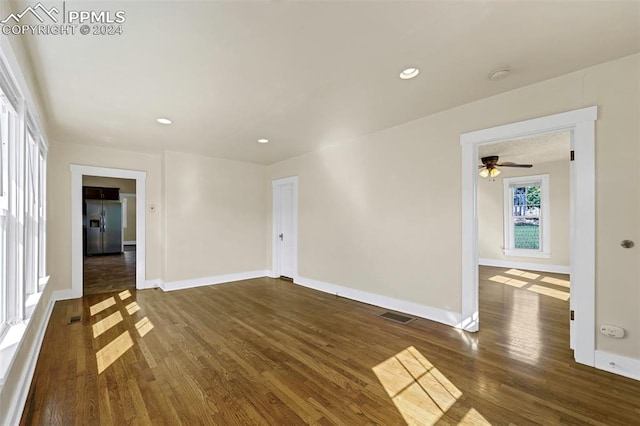 spare room featuring ceiling fan and dark hardwood / wood-style flooring