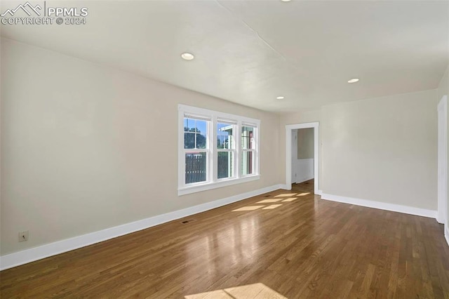 empty room with dark hardwood / wood-style floors