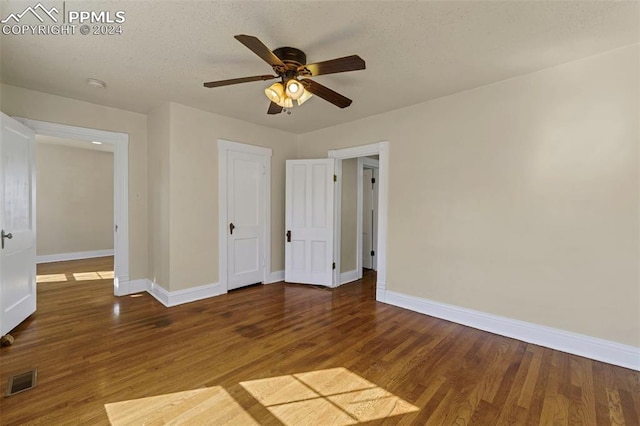 unfurnished bedroom featuring a textured ceiling, ceiling fan, and hardwood / wood-style flooring