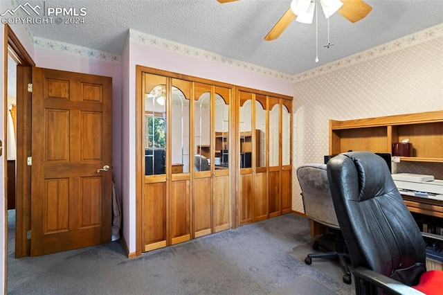 office area featuring ceiling fan, carpet floors, and a textured ceiling