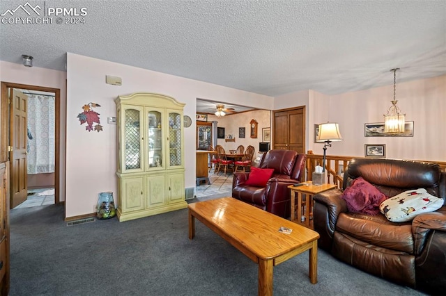 carpeted living room featuring ceiling fan with notable chandelier and a textured ceiling