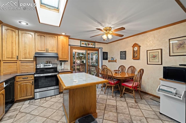 kitchen featuring a kitchen island, black appliances, ceiling fan, a skylight, and ornamental molding