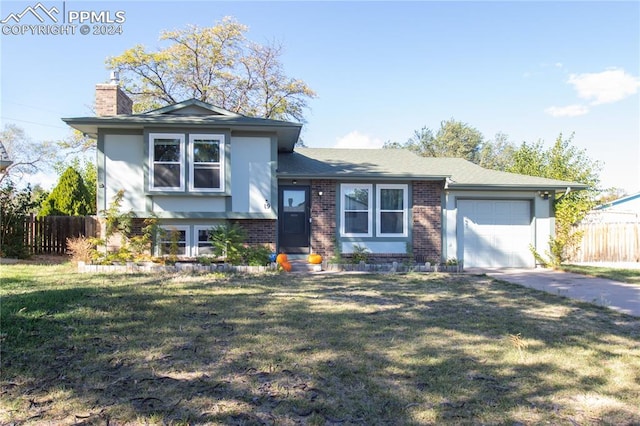 tri-level home featuring a front yard and a garage