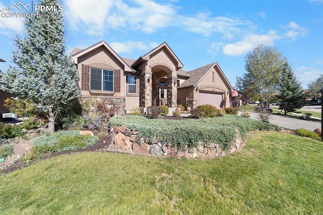 view of front of property with a front lawn and a garage