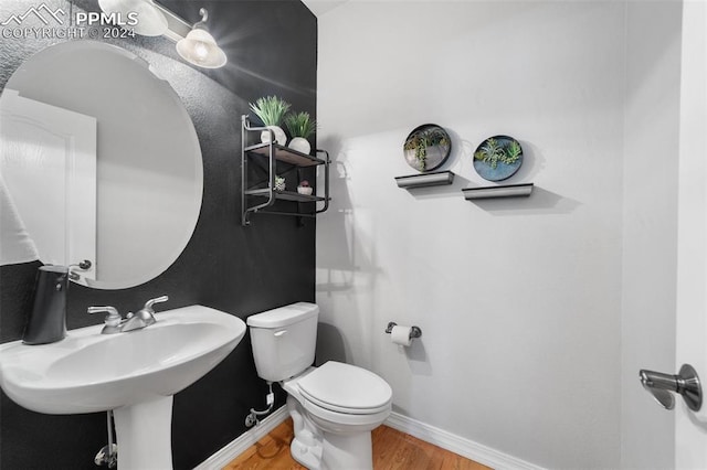 bathroom featuring hardwood / wood-style flooring and toilet