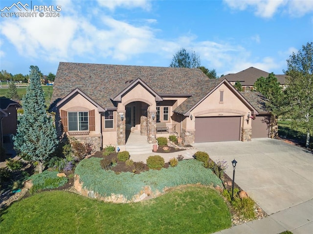 view of front facade with a front yard and a garage