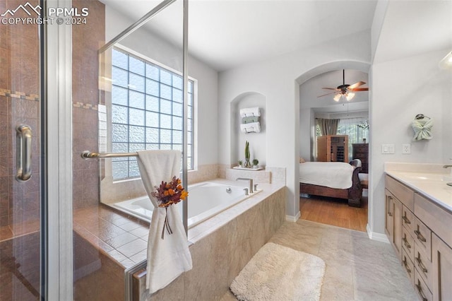 bathroom with tile patterned floors, ceiling fan, independent shower and bath, and vanity