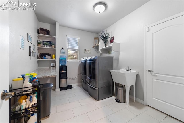 clothes washing area featuring separate washer and dryer and light tile patterned floors