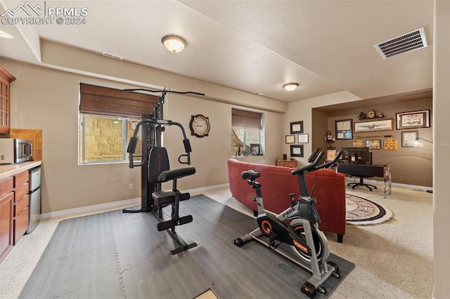 workout room with a textured ceiling