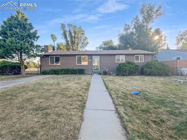 ranch-style home with a front lawn