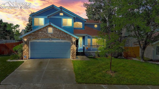 view of front of home with a yard and a garage