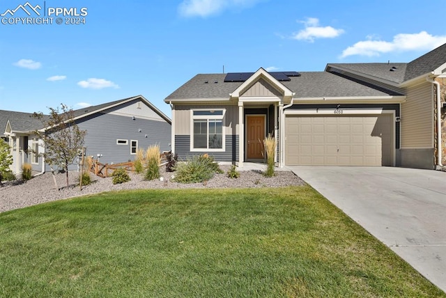 view of front of property featuring a garage and a front lawn