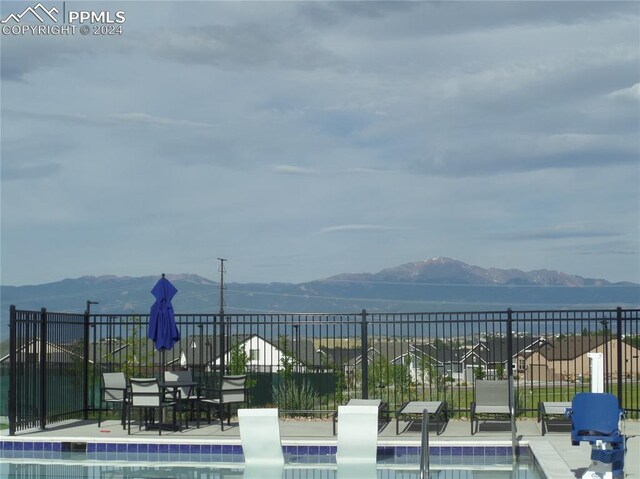 view of community featuring a mountain view and a lawn