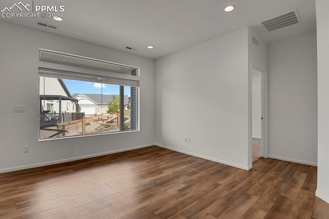 empty room with hardwood / wood-style floors