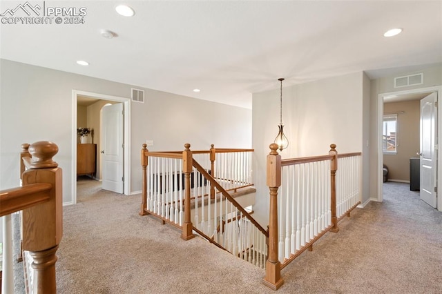 hallway featuring light carpet