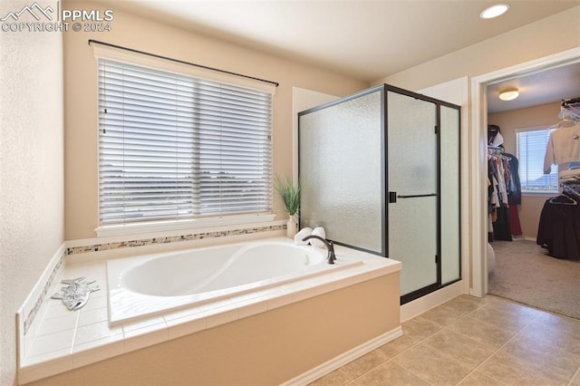 bathroom featuring separate shower and tub and tile patterned flooring