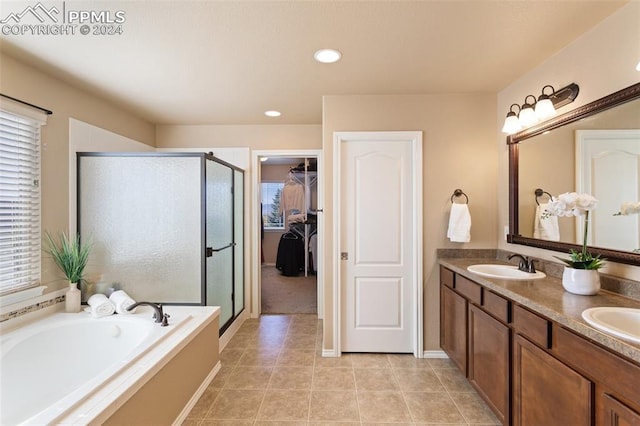 bathroom featuring plus walk in shower, tile patterned floors, and vanity