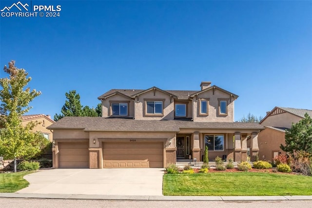 view of front of house with a garage and a front yard