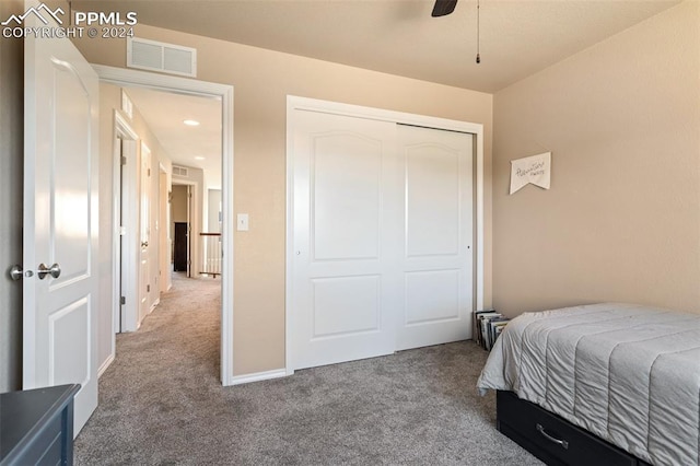 carpeted bedroom featuring a closet and ceiling fan