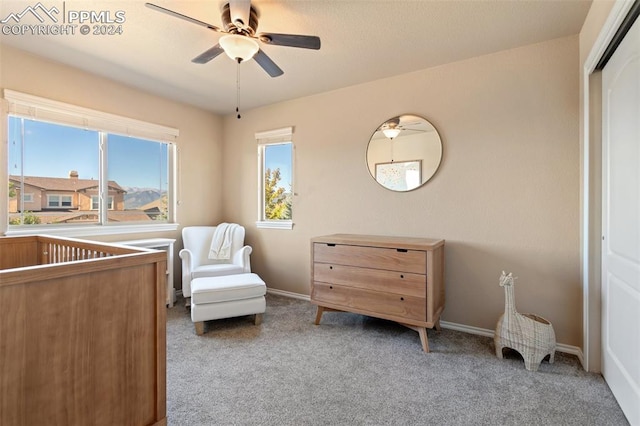 sitting room featuring ceiling fan and light colored carpet