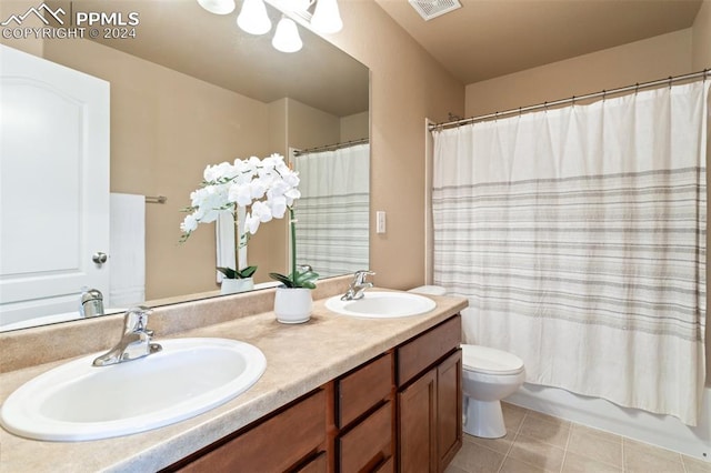 full bathroom with shower / tub combo, tile patterned floors, vanity, and toilet