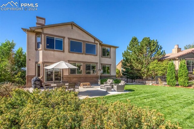 rear view of property with an outdoor hangout area, a patio, and a yard