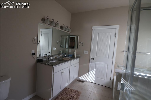 bathroom with vanity, toilet, and tile patterned floors