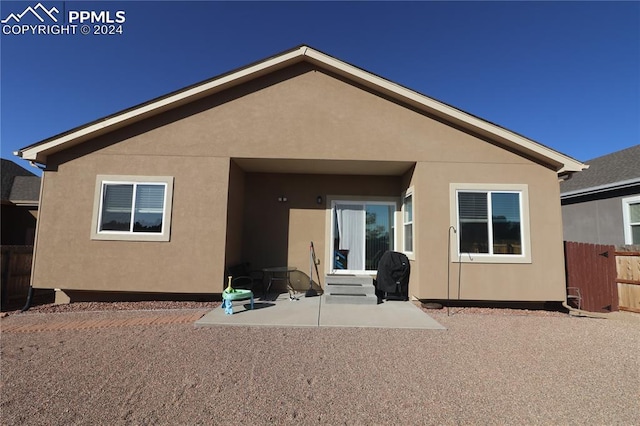 rear view of property featuring a patio area