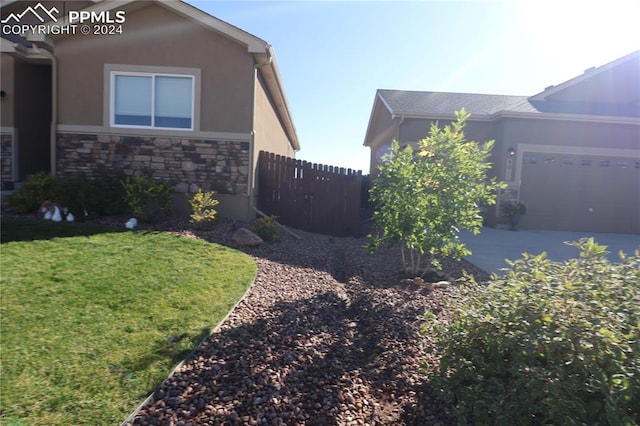 view of home's exterior with a yard and a garage