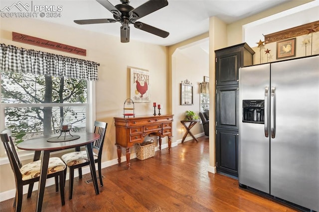 kitchen featuring ceiling fan, stainless steel refrigerator with ice dispenser, and dark hardwood / wood-style flooring