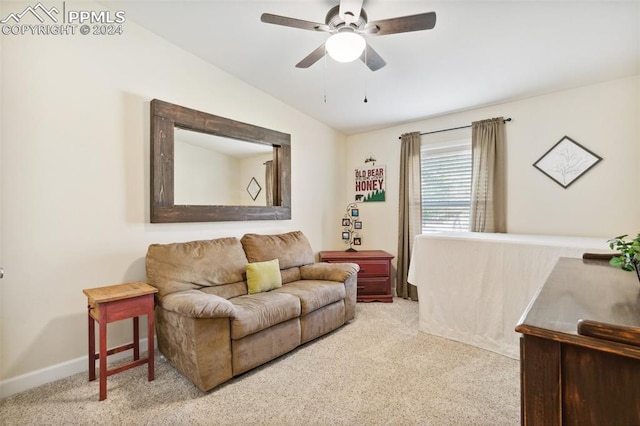 living room featuring lofted ceiling, ceiling fan, and light colored carpet