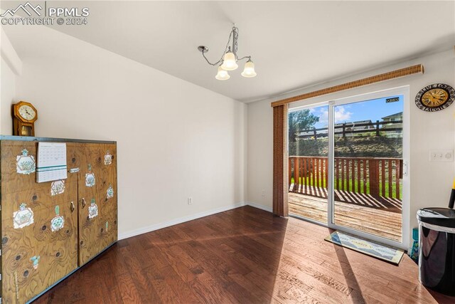 interior space with an inviting chandelier and dark wood-type flooring