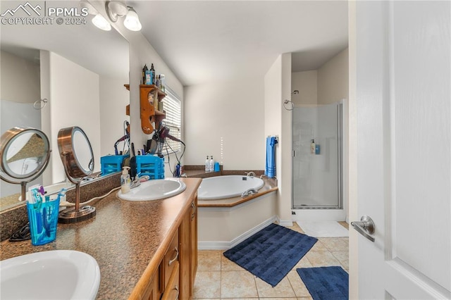 bathroom featuring shower with separate bathtub, tile patterned flooring, and vanity