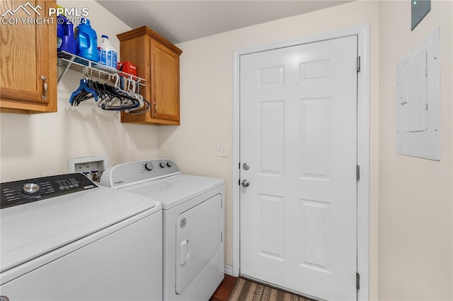 clothes washing area with cabinets, electric panel, dark hardwood / wood-style floors, and washing machine and dryer