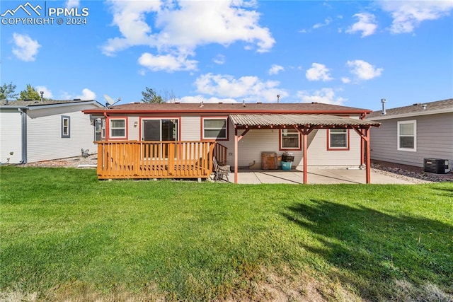 back of property with a patio, central AC unit, and a yard