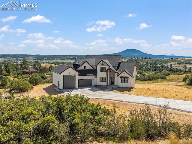 modern farmhouse style home featuring a mountain view and a garage