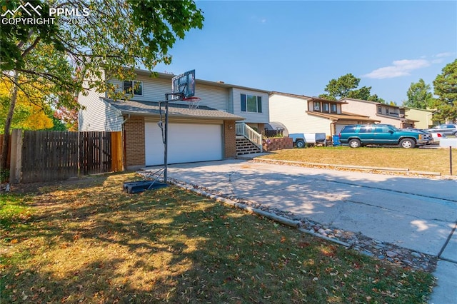 view of property featuring a front lawn and a garage