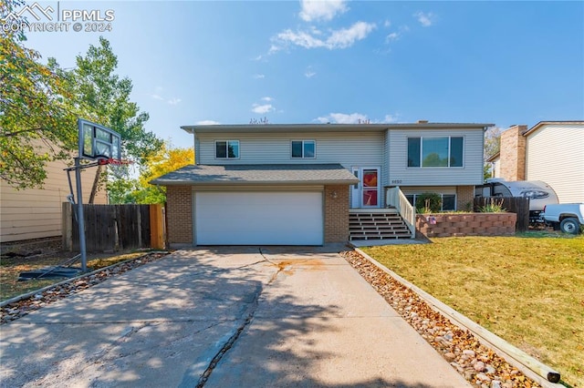 split foyer home featuring a front yard and a garage