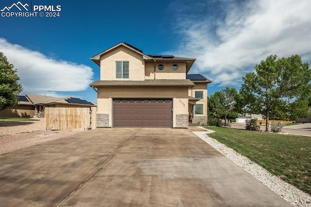 view of front of property featuring a front yard and a garage