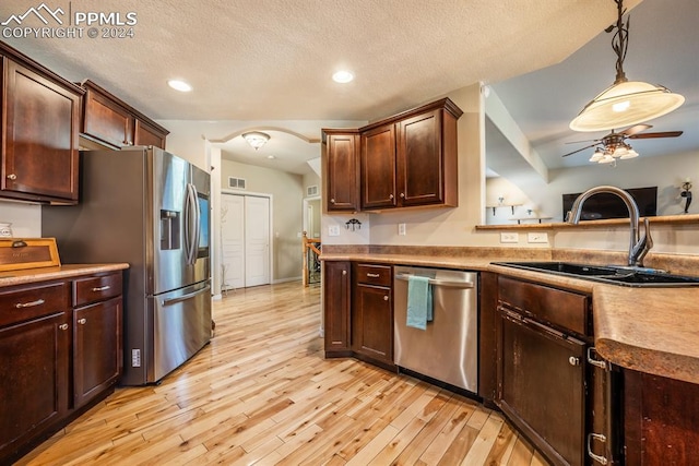 kitchen featuring pendant lighting, light wood-type flooring, sink, appliances with stainless steel finishes, and ceiling fan