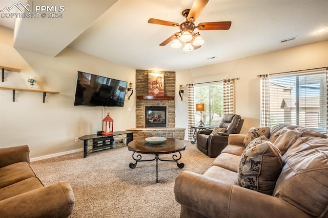 carpeted living room featuring ceiling fan and a fireplace