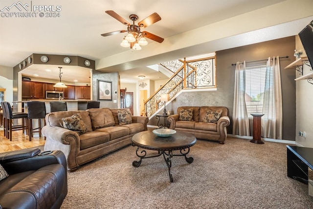 living room with wood-type flooring and ceiling fan