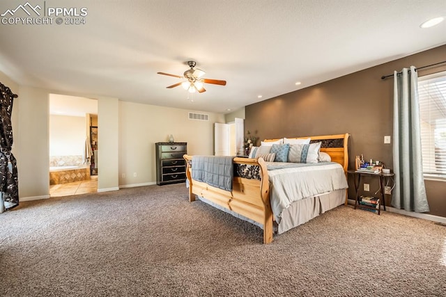 bedroom with carpet floors, ensuite bath, and ceiling fan