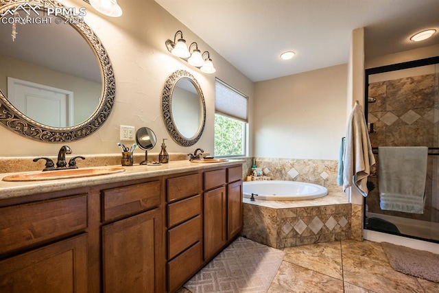 bathroom featuring independent shower and bath and vanity