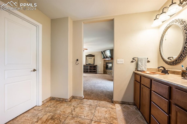 bathroom with vanity, a fireplace, and tile patterned flooring