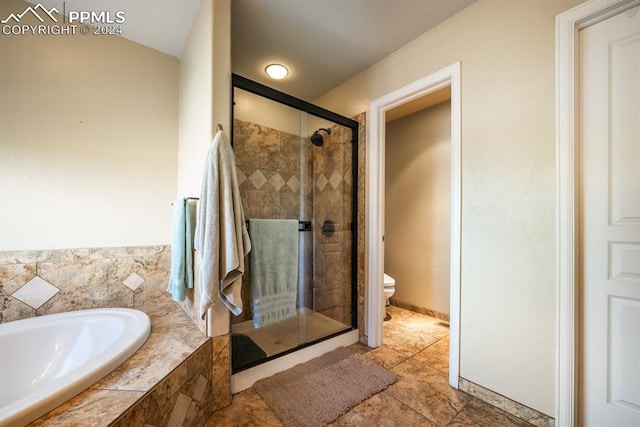 bathroom with shower with separate bathtub and toilet