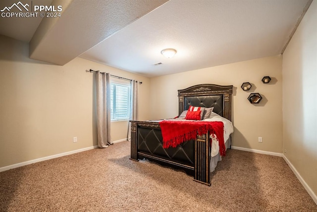 carpeted bedroom with a textured ceiling