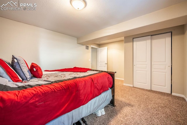 bedroom with a closet and carpet flooring