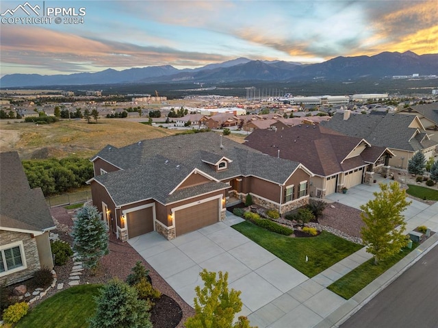 aerial view at dusk featuring a mountain view