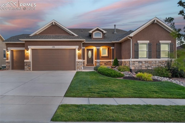 view of front facade featuring a garage and a lawn